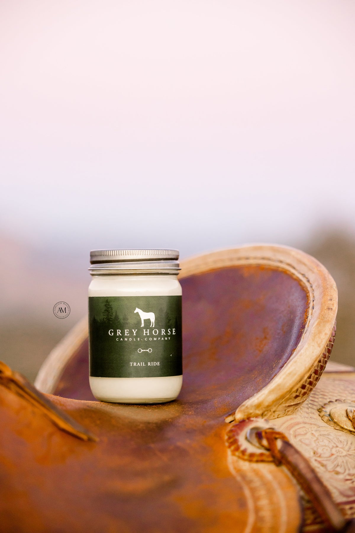 Jar of Grey Horse Leather Care on a leather surface with a blurred background