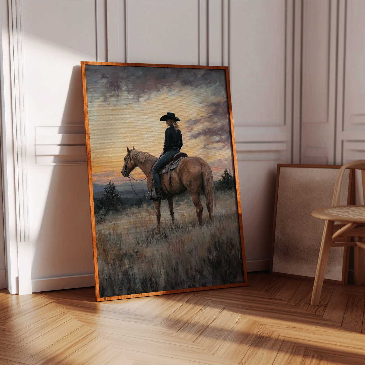 Framed painting of a person on horseback in a room with wooden floor and chair.
