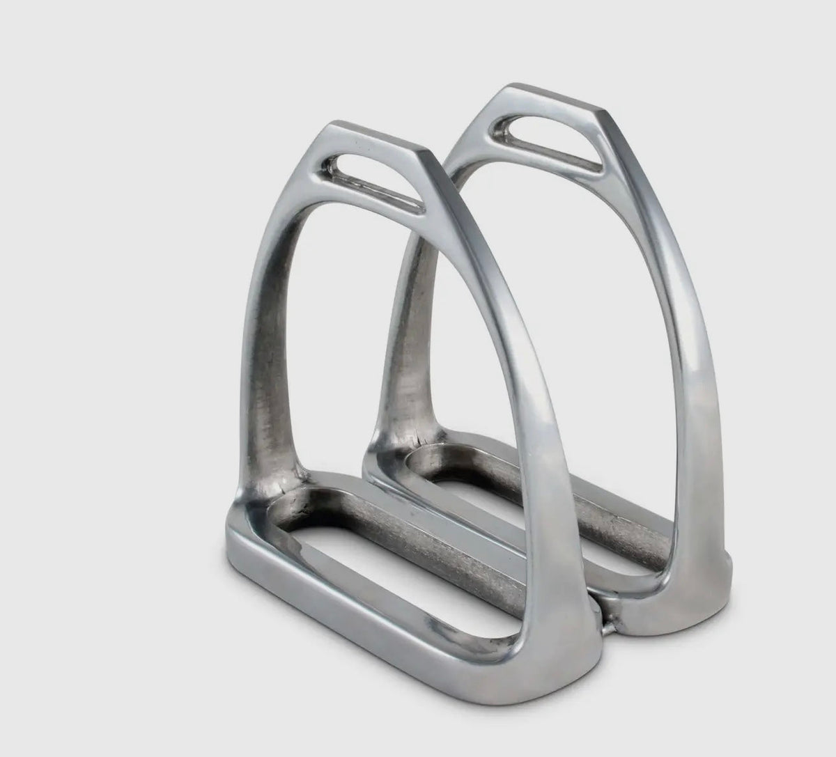 Pair of metallic equestrian stirrups on a light gray background