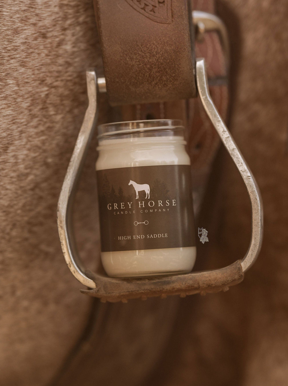 Jar of Grey Horse Leather Company product in a leather stirrup