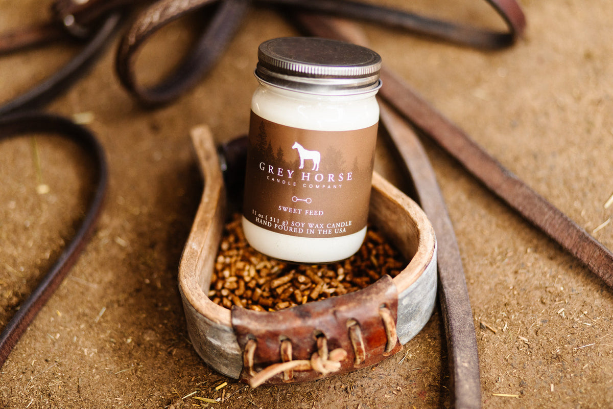 Jar of Grey Horse Leather Care products on a rustic background with leather straps.