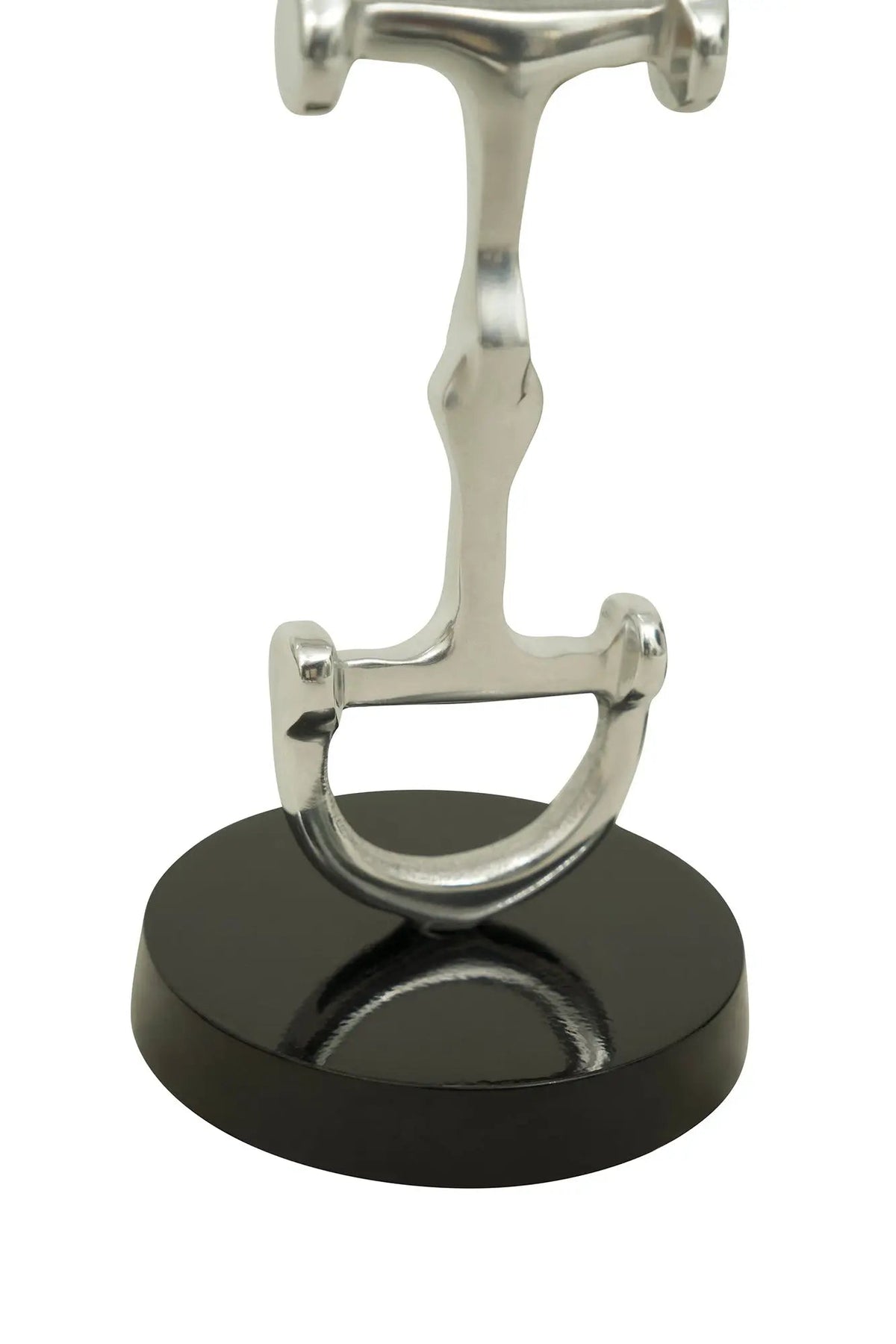 Metal horse bit on a black base against a white background