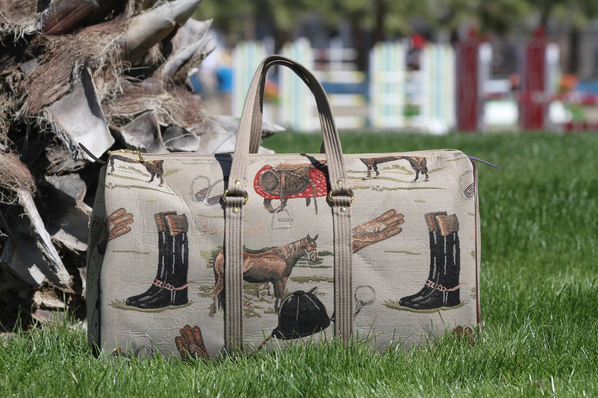Patterned handbag with animal and boot designs on grass