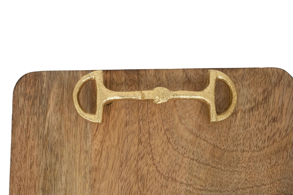 Wooden cutting board with a brass horse bit handle on a white background