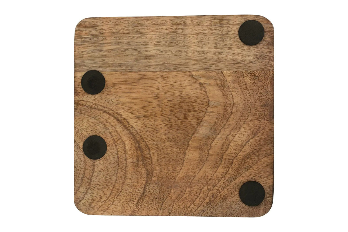 Wooden cutting board with four black magnetic buttons on a white background