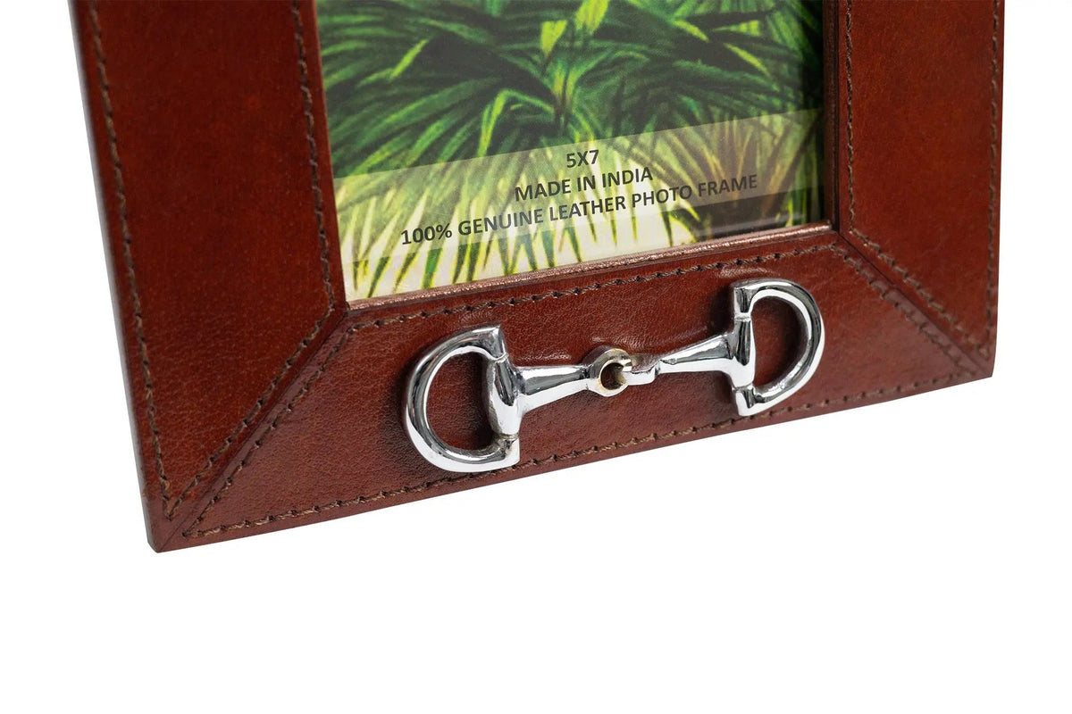 Brown leather photo frame with silver horse bit design on a white background