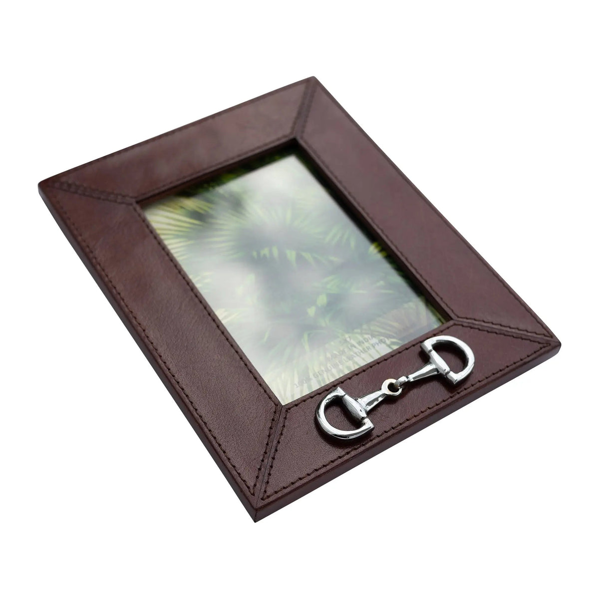 A dark brown leather picture frame with a horsebit hardware accent on the bottom right corner, shown on a plain white background.