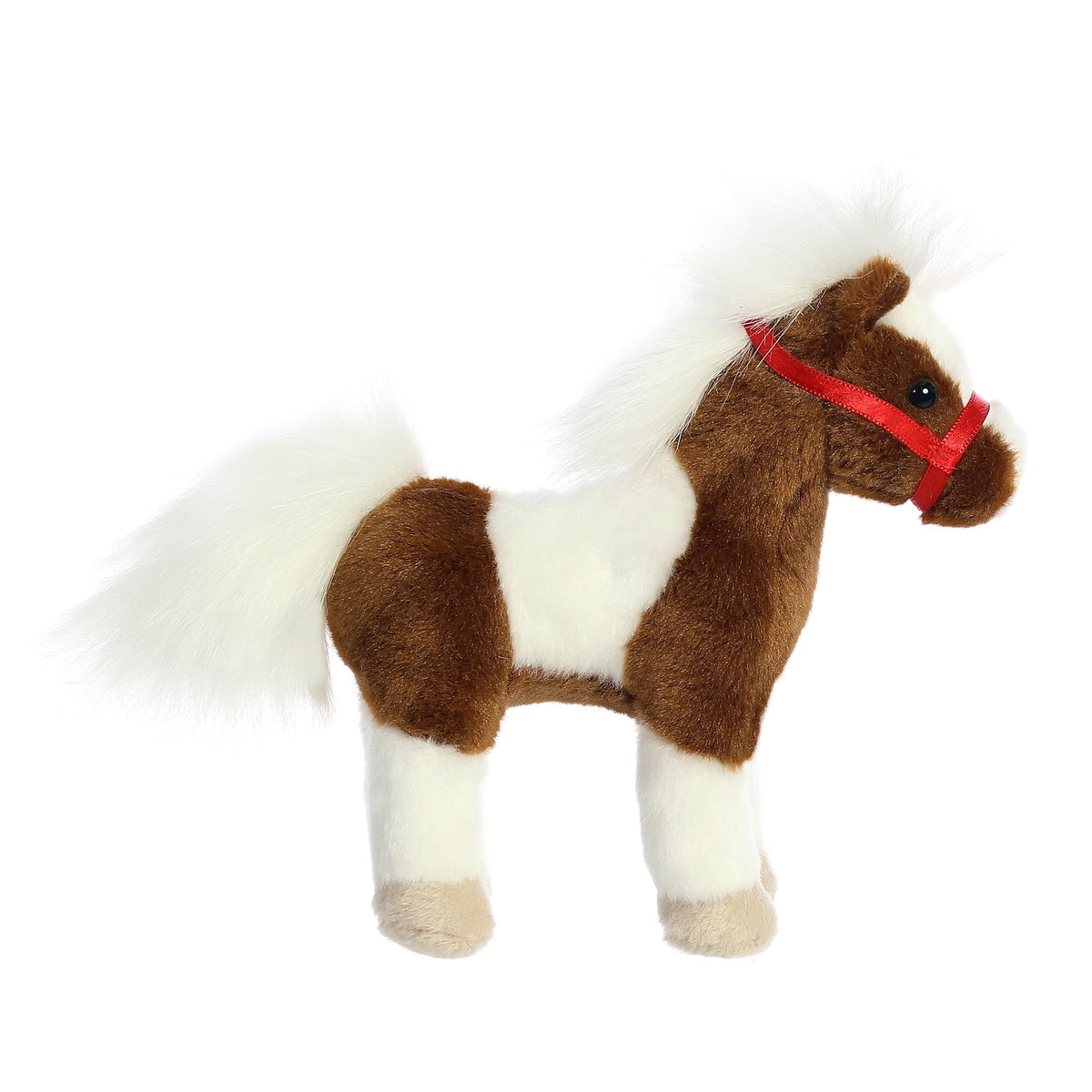 Plush toy horse with brown and white fur and a red halter on a white background