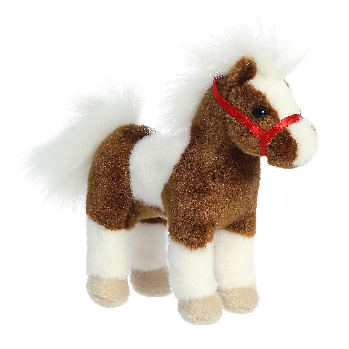 Plush toy horse with a red bridle on a white background